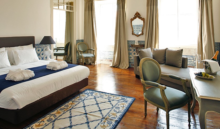 Boutique hotels in Lisbon include Palacio Ramalhete with luxury room shown