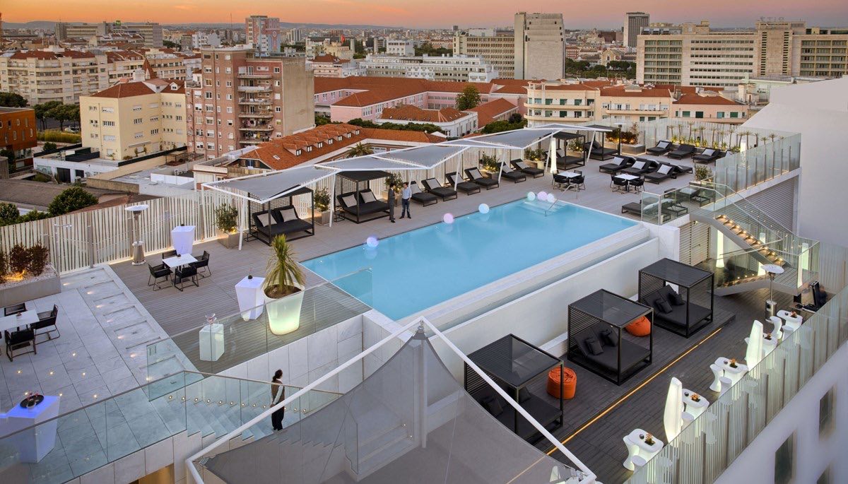 EPIC SANA Lisboa Hotel rooftop swimming pool luxury spa hotels in Lisbon at dusk