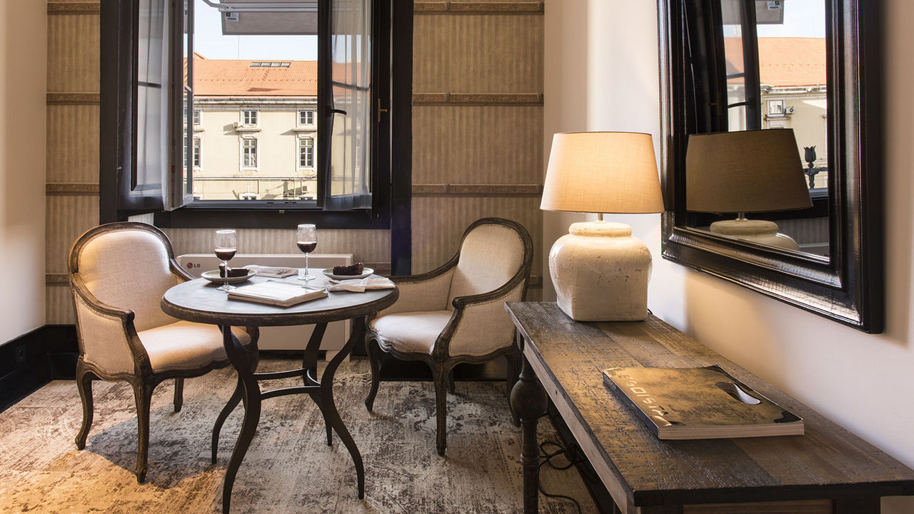 The best boutique hotels in Lisbon include the chic AlmaLusa Baixa/Chiado with lounge area and city view shown here